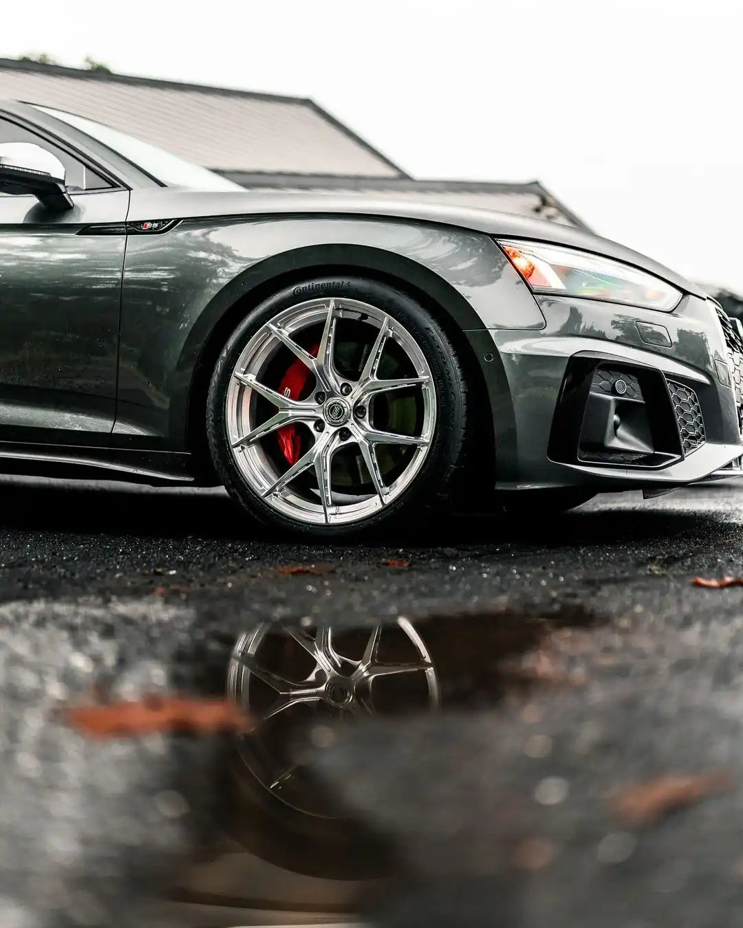 Gray Audi S5 Coupe with custom silver multi-spoke wheels and red brake calipers.
