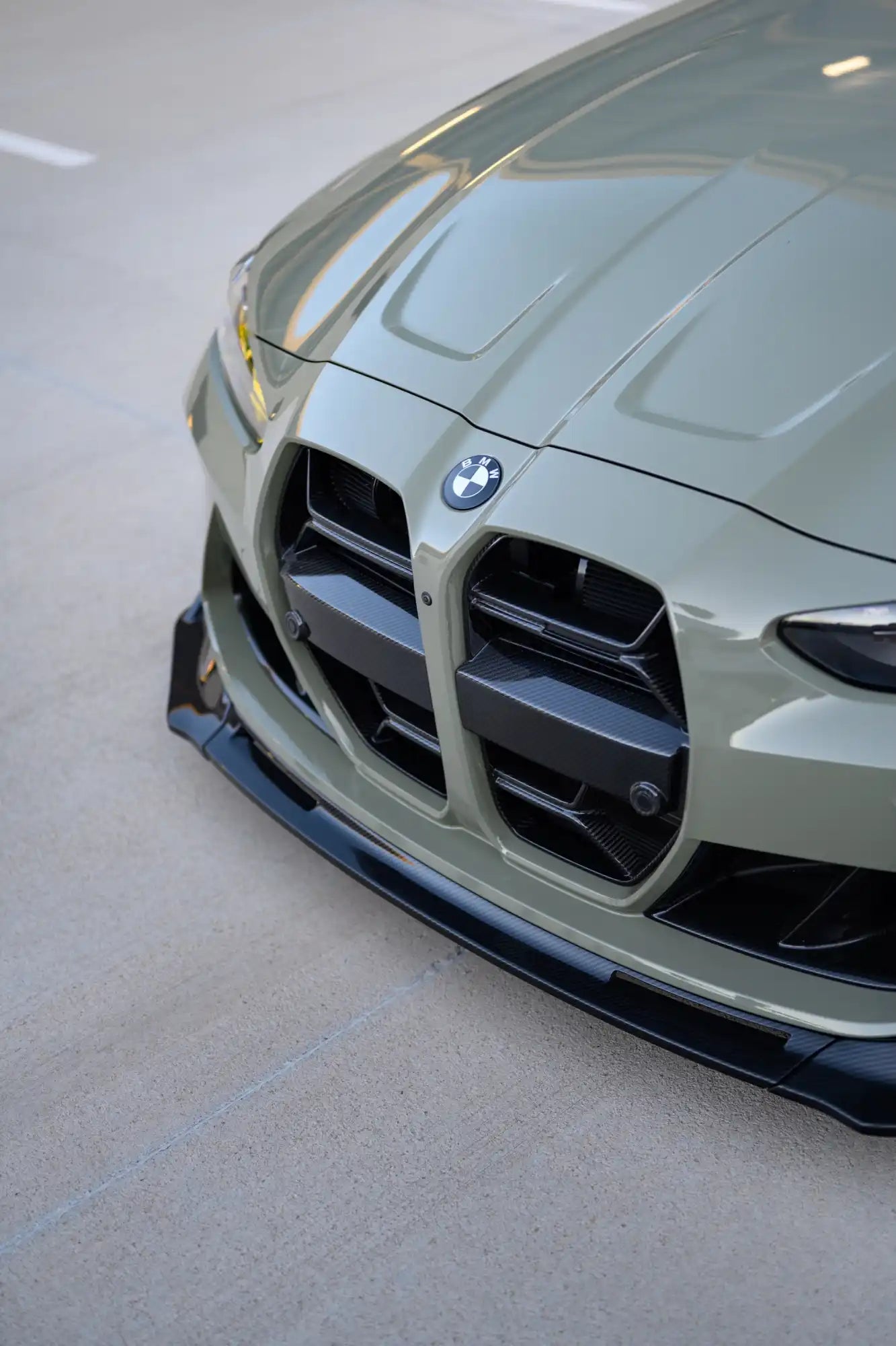 Front view of a modern sage green BMW sports car.